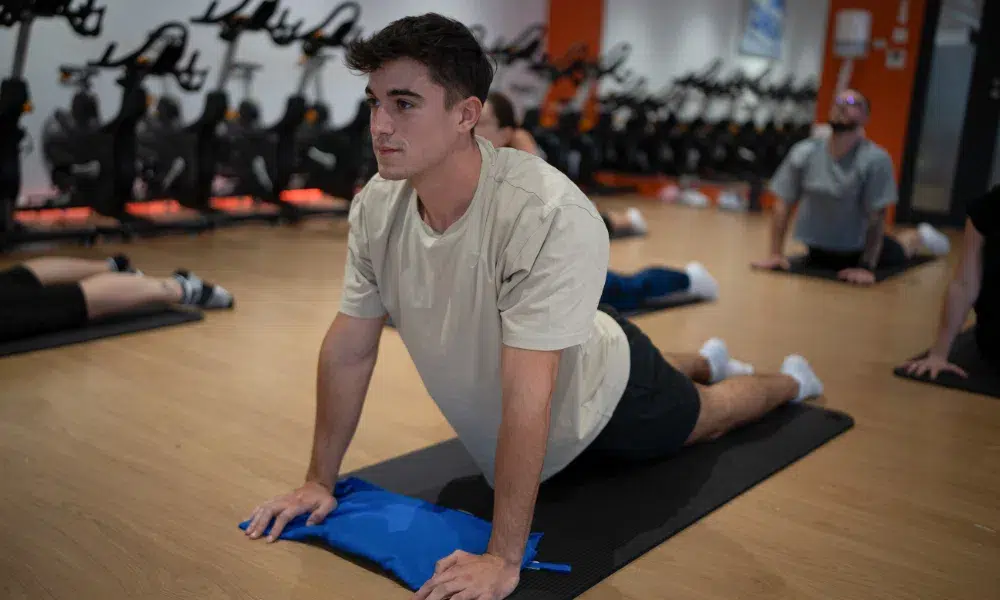 chico estirando abdominales en clase de yoga